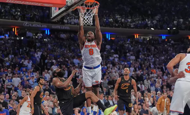 Cleveland Cavaliers' James Harden, bottom left, fouls New York Knicks' Og Anunoby during the overtime period of Game 1 in the Eastern Conference finals NBA basketball playoffs series Tuesday, May 19, 2026, in New York. (AP Photo/Seth Wenig)