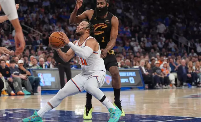 New York Knicks' Jalen Brunson, bottom, drives past Cleveland Cavaliers' James Harden during the second half of Game 1 in the Eastern Conference finals NBA basketball playoffs series Tuesday, May 19, 2026, in New York. (AP Photo/Seth Wenig)
