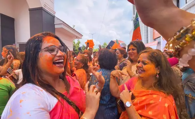 Bharatiya Janata Party workers shout slogans and celebrate the party's early results and lead in the recently held state election, in Guwahati, India, Monday, May 4, 2026. (AP Photo/Anupam Nath)