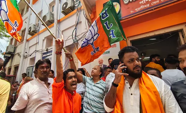 Bharatiya Janata Party members shout slogans and react to earlier results in a recently held state election, in Kolkata, India, Monday, May 4, 2026. (AP Photo/Bikas Das)