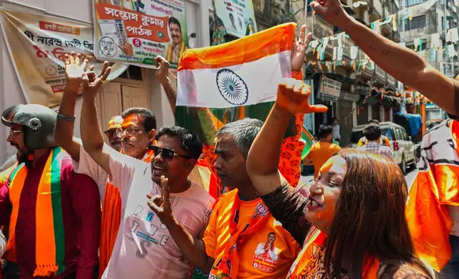 Bharatiya Janata Party members shout slogans and react to earlier results in a recently held state election, in Kolkata, India, Monday, May 4, 2026. (AP Photo/Bikas Das)