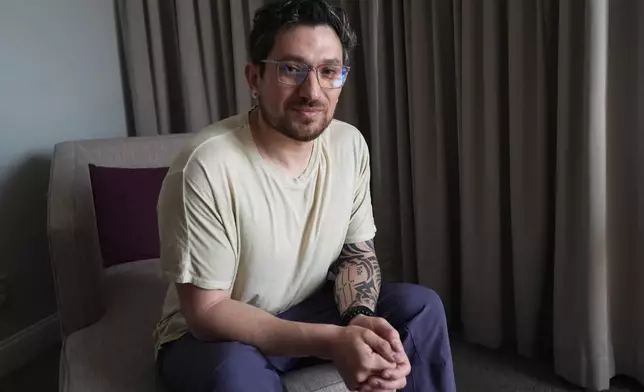 Kyle Adler, a 36-year-old Chilean American taken from his family at nine months old and illegally adopted, poses for a photo in Miami, Friday, Feb. 13, 2026, before heading to the airport to travel to Chile to meet his birth mother. (AP Photo/Marta Lavandier)