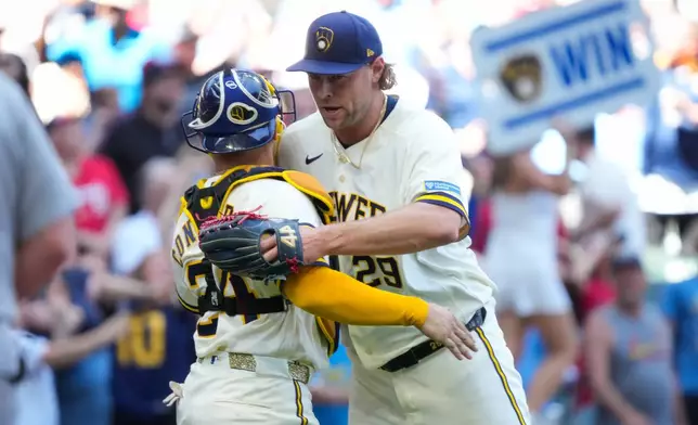 Milwaukee Brewers pitcher Trevor Megill (29) hugs William Contreras (24) after winning against the St. Louis Cardinals in a baseball game Wednesday, May 27, 2026, in Milwaukee. (AP Photo/Kayla Wolf)