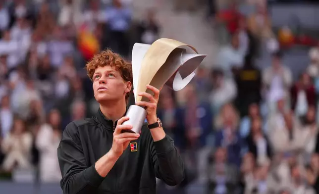 Jannik Sinner, of Italy, holds the trophy after winning the men's singles tennis final match against Alexander Zverev, of Germany, at the Madrid Open tennis tournament in Madrid, Spain, Sunday, May 3, 2026. (AP Photo/Manu Fernandez)