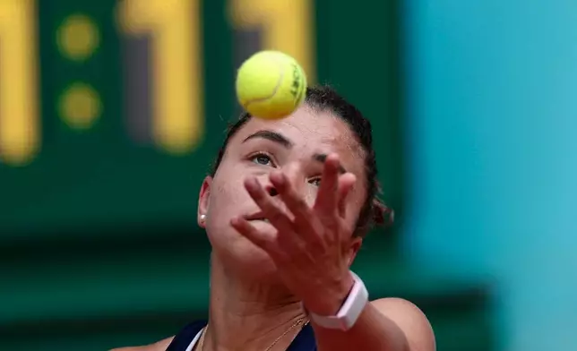 Jasmine Paolini of Italy serves to Hailey Baptiste of the U.S. during the Madrid Open tennis tournament in Madrid, Saturday, April 25, 2026. (AP Photo/Pablo Garcia)