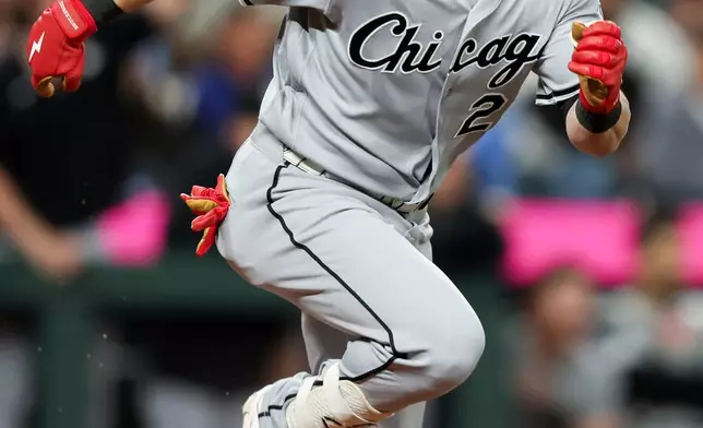 Chicago White Sox designated hitter Andrew Benintendi runs to first after hitting an RBI in the ninth inning of a baseball game against the Seattle Mariners, Tuesday, May 19, 2026, in Seattle. (AP Photo/Kevin Ng)