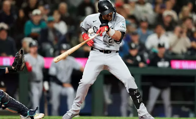 Chicago White Sox's Miguel Vargas is hit by a pitch in the ninth inning of a baseball game against the Seattle Mariners, Tuesday, May 19, 2026, in Seattle. (AP Photo/Kevin Ng)