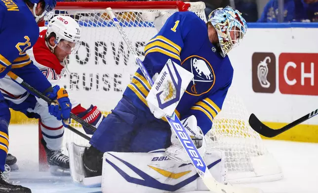 Montreal Canadiens center Jake Evans (71) puts the puck behind Buffalo Sabres goaltender Ukko-Pekka Luukkonen (1) during the second period in Game 5 of a second-round NHL hockey Stanley Cup playoff series, Thursday, May 14, 2026, in Buffalo, N.Y. (AP Photo/Jeffrey T. Barnes)