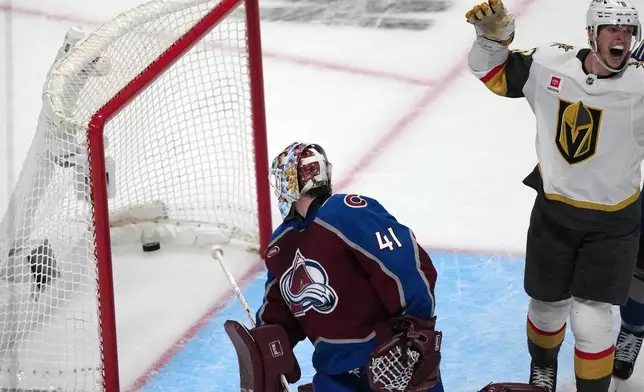 Colorado Avalanche goaltender Scott Wedgewood, left, looks back in the net to see the puck as Vegas Golden Knights right wing Pavel Dorofeyev celebrates after a goal by left wing Ivan Barbashev during the third period in Game 2 of the Western Conference finals NHL hockey Stanley Cup playoff series Friday, May 22, 2026, in Denver. (AP Photo/David Zalubowski)