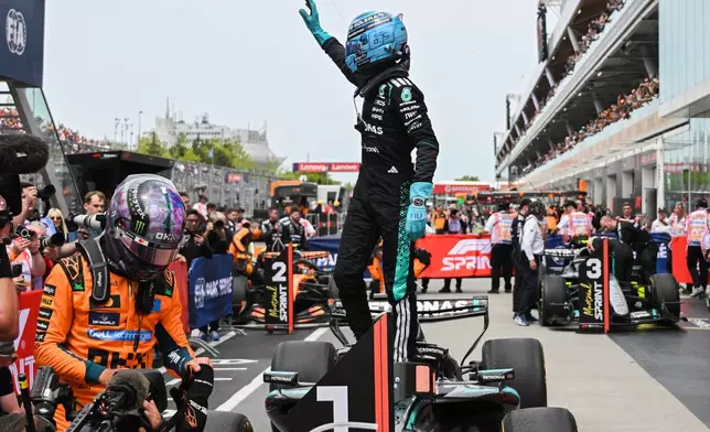 Mercedes driver George Russell, of Britain, waves after winning the sprint race at the F1 Canadian Grand Prix auto race in Montreal, Saturday, May 23, 2026. (Graham Hughes/The Canadian Press via AP)