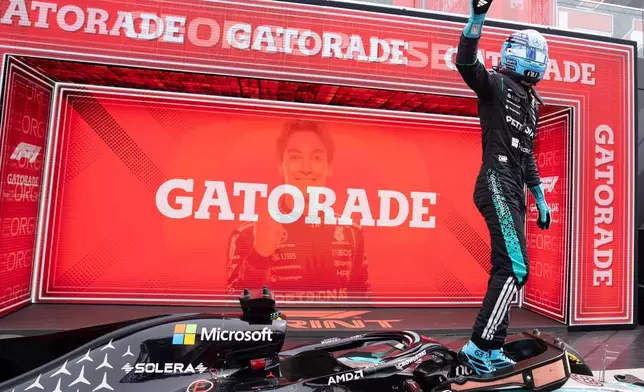 Mercedes driver George Russell, of Britain, waves after winning the sprint race at the F1 Canadian Grand Prix auto race in Montreal, Saturday, May 23, 2026. (Christinne Muschi/The Canadian Press via AP)