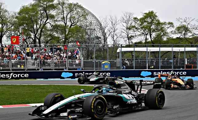 Mercedes driver George Russell, of Britain, followed by McLaren driver Lando Norris, right, of Britain and Mercedes driver Kimi Antonelli, of Italy, navigates a turn during the sprint race at the F1 Canadian Grand Prix auto race in Montreal, Saturday, May 23, 2026. (Jacques Boissinot/The Canadian Press via AP)
