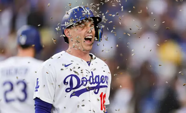 Los Angeles Dodgers designated hitter Will Smith has sunflower seeds thrown at him after hitting a solo home run during the first inning of a baseball game against the San Francisco Giants, Thursday, May 14, 2026, in Los Angeles. (AP Photo/Ryan Sun)