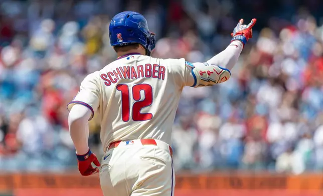 Philadelphia Phillies' Kyle Schwarber gestures while rounding second base after hitting a solo home run in the first inning of a baseball game against the Colorado Rockies, Sunday, May 10, 2026, in Philadelphia. (AP Photo/Laurence Kesterson)