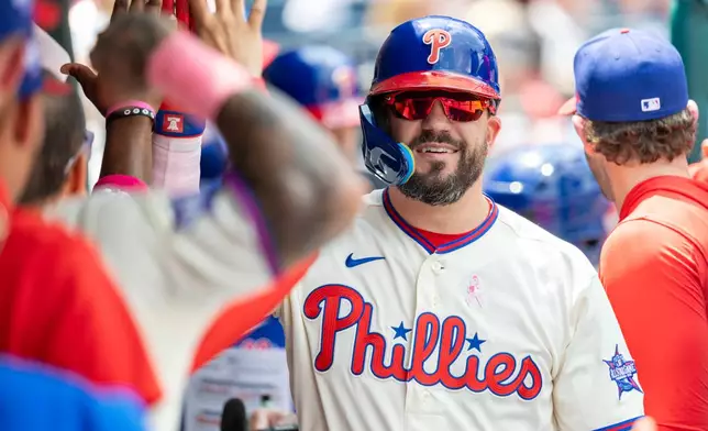 Philadelphia Phillies' Kyle Schwarber is cheered in the dugout after hitting a solo home run in the first inning of a baseball game against the Colorado Rockies, Sunday, May 10, 2026, in Philadelphia. (AP Photo/Laurence Kesterson)