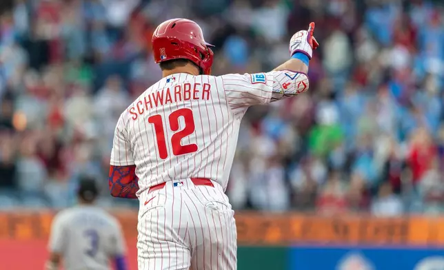 Philadelphia Phillies' Kyle Schwarber gestures after hitting a three-run home run in the third inning of a baseball game against the Colorado Rockies, Saturday, May 9, 2026, in Philadelphia. (AP Photo/Laurence Kesterson)