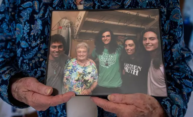Gretna Van Fleet smiles holds a photograph of her with the band Greta Van Fleet at her home in Frankenmuth, Mich, Monday, Jan. 14, 2019. (Kaytie Boomer/Saginaw News via AP)
