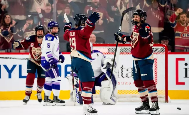 Montreal Victoire's Catherine Dubois (right) celebrates her goal with Marie-Philip Poulin (29) after scoring against the Minnesota Frost during first period of an PWHL playoff hockey game in Laval, Que., on Tuesday, May 12, 2026. (Christopher Katsarov/The Canadian Press via AP)
