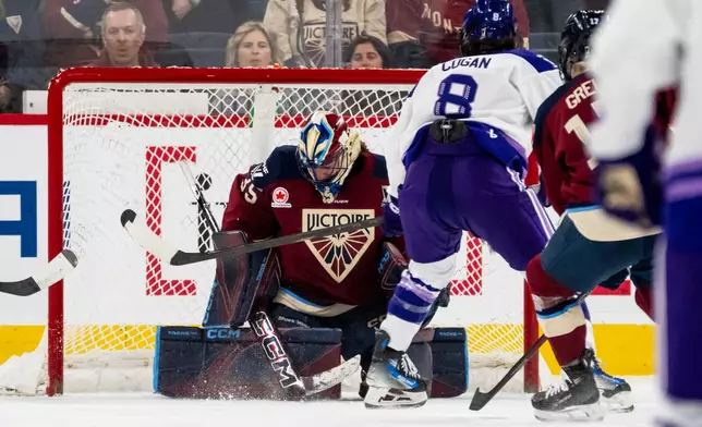 Minnesota Frost's Samantha Cogan (8) scores on Montreal Victoire goaltender Ann-Renee Desbiens (35) during the second period of a PWHL hockey playoff game in Laval, Quebec, on Tuesday, May 12, 2026. (Christopher Katsarov/The Canadian Press via AP)