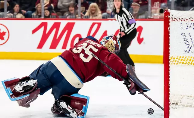 Montréal Victoire goaltender Ann-Renee Desbiens (35) reaches back to make a save against the Minnesota Frost during the first period of a PWHL hockey playoff game in Laval, Quebec, on Tuesday, May 12, 2026. (Christopher Katsarov/The Canadian Press via AP)