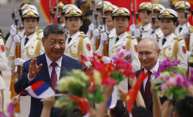 Russian President Vladimir Putin, right, and Chinese President Xi Jinping attend a welcoming ceremony at the Great Hall of the People in Beijing Wednesday, May 20, 2026. (Maxim Shemetov/Pool Photo via AP)