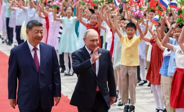Russian President Vladimir Putin, center, and Chinese President Xi Jinping attend a welcome ceremony at the Great Hall of the People, in Beijing, China, on Wednesday, May 20, 2026. (Alexander Kazakov, Sputnik, Kremlin Pool Photo via AP)