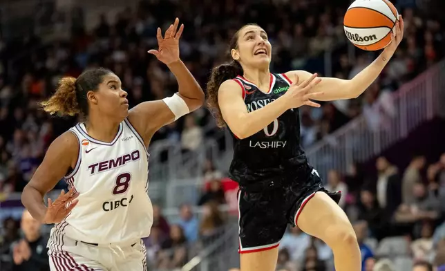 Portland Fire guard Carle Leite (0) drives to the basket past Toronto Tempo forward Nyara Sabally (8) during first-half WNBA basketball game action in Toronto, Saturday May 23, 2026. (Frank Gunn/The Canadian Press via AP)