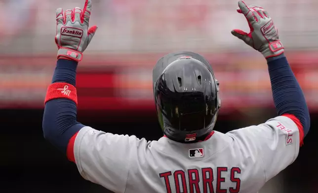 St. Louis Cardinals' Bryan Torres celebrates hitting a single, his first career hit on his MLB debut, during the fourth inning of the first baseball game of a doubleheader against the Cincinnati Reds in Cincinnati, Saturday, May 23, 2026. (AP Photo/Carolyn Kaster)