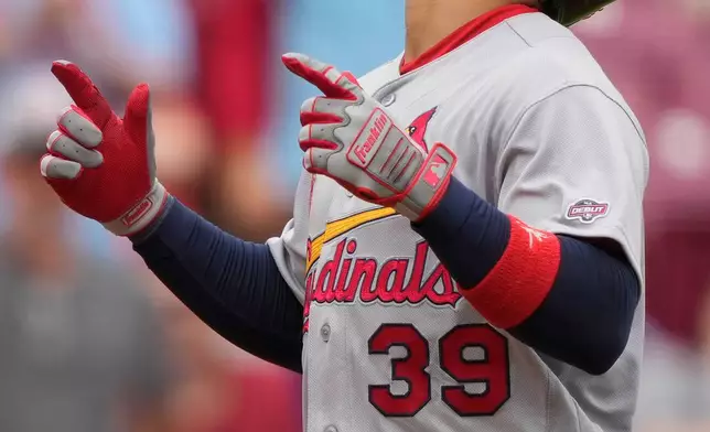 St. Louis Cardinals' Bryan Torres celebrates as he runs the bases after Torres hitting a two-run homer in the ninth inning of the first baseball game of a doubleheader against the Cincinnati Reds in Cincinnati, Saturday, May 23, 2026. (AP Photo/Carolyn Kaster)