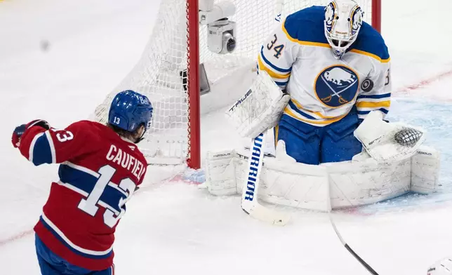 Buffalo Sabres goaltender Alex Lyon (34) makes a save against Montreal Canadiens' Cole Caufield (13) during the first period of Game 3 in a second-round NHL hockey Stanley Cup playoff series in Montreal, Sunday, May 10, 2026. (Christinne Muschi/The Canadian Press via AP)