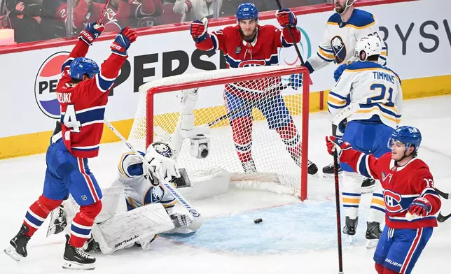 Montreal Canadiens' Cole Caufield (13) reacts after scoring against Buffalo Sabres goaltender Alex Lyon, second from left,during the second period of Game 3 in a second-round NHL hockey Stanley Cup playoff series in Montreal, Sunday, May 10, 2026. (Graham Hughes/The Canadian Press via AP)
