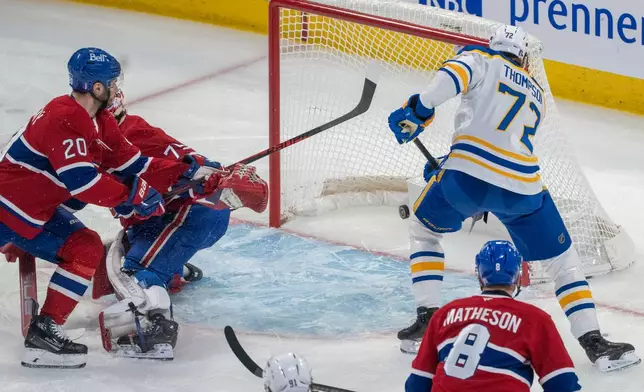 Buffalo Sabres' Tage Thompson (72) scores on Montreal Canadiens goaltender Jakub Dobes (75) as Canadiens' Juraj Slafkovsky (20) defends during the first period of Game 3 in a second-round NHL hockey Stanley Cup playoff series in Montreal, Sunday, May 10, 2026. (Christinne Muschi/The Canadian Press via AP)
