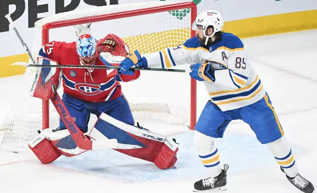 Buffalo Sabres' Alex Tuch (89) tries to tip the puck past Montreal Canadiens goaltender Jakub Dobes (75) during the first period of Game 3 in a second-round NHL hockey Stanley Cup playoff series in Montreal, Sunday, May 10, 2026. (Graham Hughes/The Canadian Press via AP)