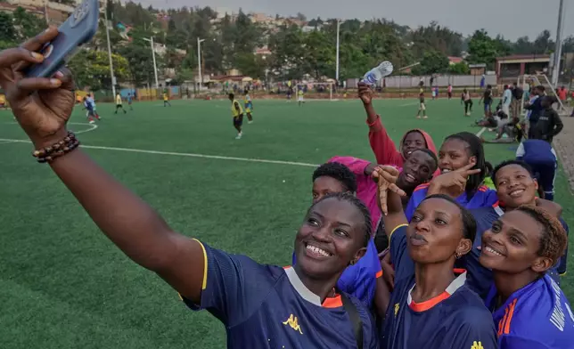 Soccer players on the Rwanda Amputee team pose for a selfie after a training session in Kigali, Rwanda, on Friday, March 20, 2026. (AP Photo/Brian Inganga)