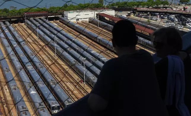 Visitors look out at the trains at the West Side Yard from the Vessel on the first day of a Long Island Rail Road workers' strike, Saturday, May 16, 2026, in New York. (AP Photo/Heather Khalifa)