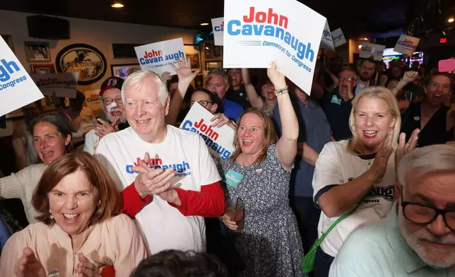 From front left, parents Kate and John Cavanaugh, sister-in-law Audra Cavanaugh and friend Michelle Sullivan cheer for State Sen. John Cavanaugh, candidate for the Democratic nomination to the House of Representatives in Nebraska's second district, during an election night watch party Tuesday, May 12, 2026, in Omaha, Neb. (AP Photo/Rebecca S. Gratz) ADDS NAMES