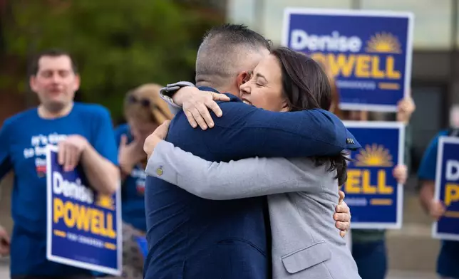 Denise Powell hugs her husband, Hobson, after voting in the Nebraska Primary Election at Omaha Community Playhouse Tuesday, May 12, 2026, in Omaha, Neb. Powell is a candidate for the Democratic nomination to the House of Representatives in Nebraska's second district. (AP Photo/Rebecca S. Gratz)