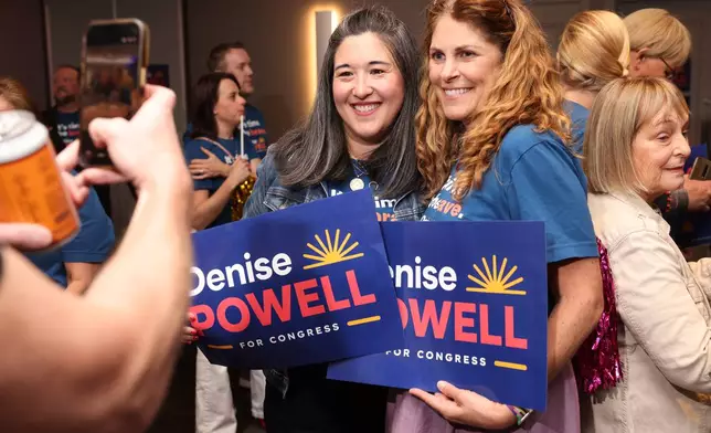 Supporters Shannon Gilroy, left, and Emily Moody pose for a photo during an election night watch party for Denise Powell, candidate for the Democratic nomination to the House of Representatives in Nebraska's second district, Tuesday, May 12, 2026, in Omaha, Neb. (AP Photo/Rebecca S. Gratz)