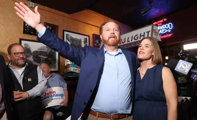 State Sen. John Cavanaugh, candidate for the Democratic nomination to the House of Representatives in Nebraska's second district, left, stands with his wife, Kakie McGill, during an election night watch party Tuesday, May 12, 2026, in Omaha, Neb. (AP Photo/Rebecca S. Gratz)