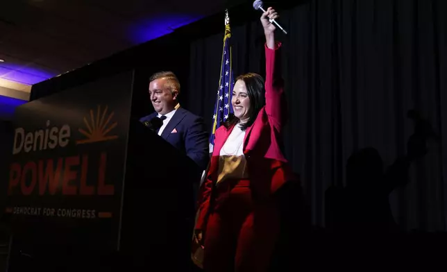 Denise Powell, right, candidate for the Democratic nomination to the House of Representatives in Nebraska's second district, cheers during an election night watch party Tuesday, May 12, 2026, in Omaha, Neb. (AP Photo/Rebecca S. Gratz)