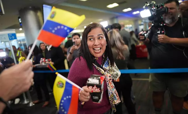 A passenger boards American Airlines Flight AA3599, the first direct commercial flight between the United States and Venezuela in seven years, Thursday, April 30, 2026, at Miami International Airport in Miami. (AP Photo/Rebecca Blackwell)