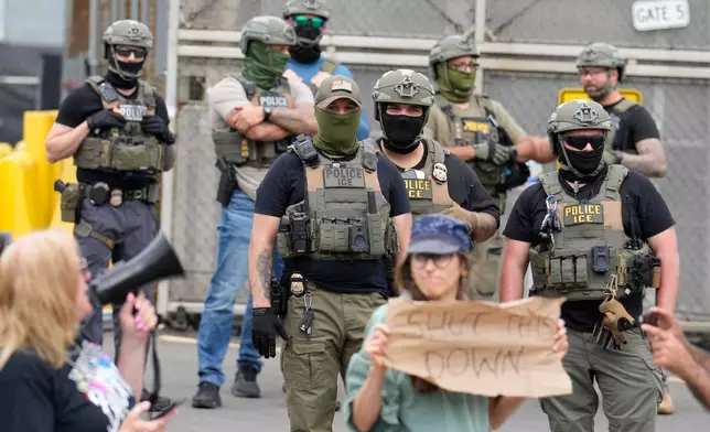 Masked federal agents stand outside the Delaney Hall detention center during a protest against the transfer of detainees on Wednesday, May 27, 2026, in Newark, N.J. (AP Photo/Seth Wenig)