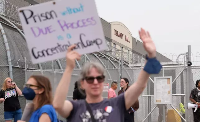 Demonstrators stand outside the Delaney Hall detention center during a protest against the transfer of detainees on Wednesday, May 27, 2026, in Newark, N.J. (AP Photo/Seth Wenig)