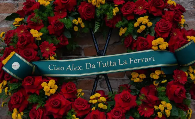 A wreath reading " Hello Alex, from all at the Ferrari ", during the funeral of Alex Zanardi, Italian auto racing champion-turned-Paralympic gold medalist, inside the Basilica of Santa Giustina, Padua, Italy, Tuesday, May 5, 2026. (Claudio Furlan/LaPresse via AP)