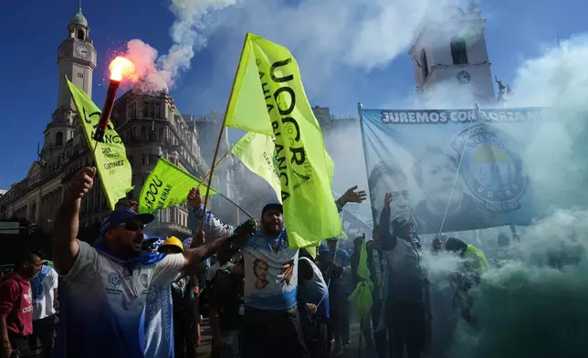 Laborers hold flares during a May Day demonstration in Buenos Aires, Argentina, Thursday, April 30, 2026. (AP Photo/Rodrigo Abd)