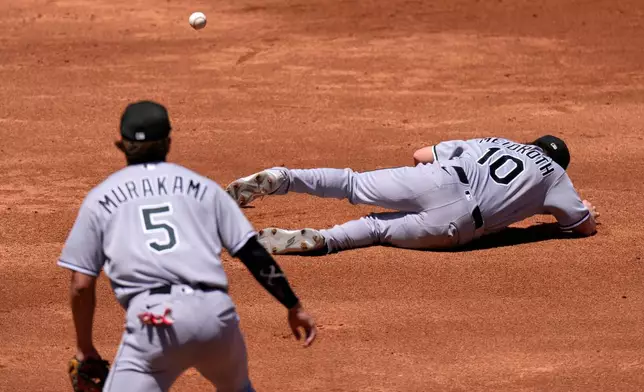 Chicago White Sox second baseman Chase Meidroth, right, falls while trying to catch a pop fly hit by Los Angeles Angels' Mike Trout as second baseman Vaughn Grissom watches during the second inning of a baseball game Wednesday, May 6, 2026, in Anaheim, Calif. (AP Photo/Mark J. Terrill)