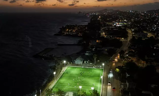 People play soccer in Willemstad, Curacao, Saturday, May 16, 2026. (AP Photo/Matias Delacroix)