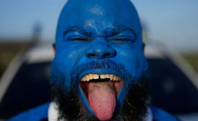 Brenton Balentien, known as Blue Face, a leader of soccer fans of Curacao's national soccer team, cheers in Willemstad, Saturday, May 16, 2026. (AP Photo/Matias Delacroix)
