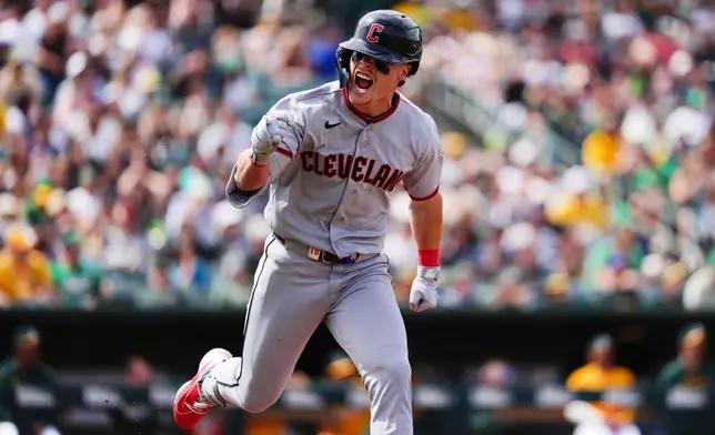 Cleveland Guardians' Travis Bazzana reacts as he runs to first base after hitting his first major league hit, a two-RBI single, in the seventh inning of a baseball game against the Athletics, Saturday, May 2, 2026, in West Sacramento, Calif. (AP Photo/Alan Greth) CORRECTION: Corrects to two-run single not two-run double.