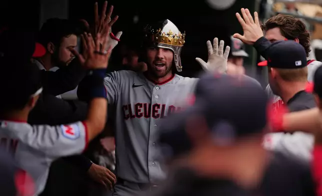 Cleveland Guardians' David Fry is greeted by teammates in the dugout after hitting a home run in the sixth inning of a baseball game against the Athletics, Saturday, May 2, 2026, in West Sacramento, Calif. (AP Photo/Alan Greth)